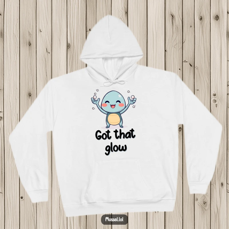 Funny hoodie featuring a giggling mussel character juggling tiny pearls with its arms, exuding pure mirth.